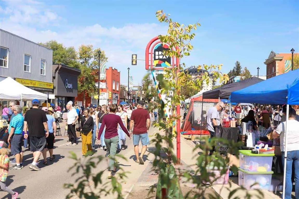 Fringe Festival on Broadway Avenue in Saskatoon with people browsing outdoor stalls and local businesses