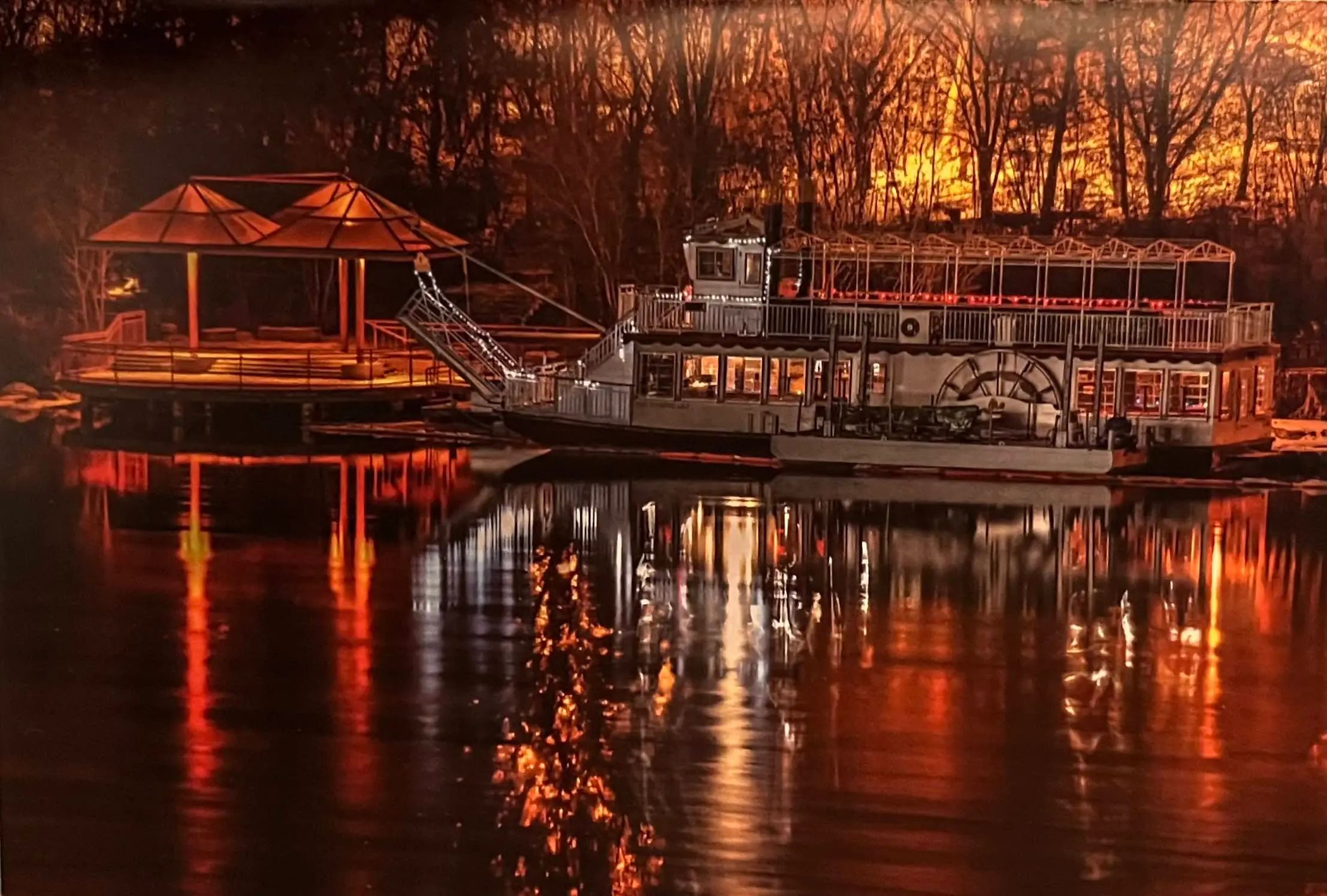 Prairie Lily riverboat illuminated at sunset along the South Saskatchewan River.
