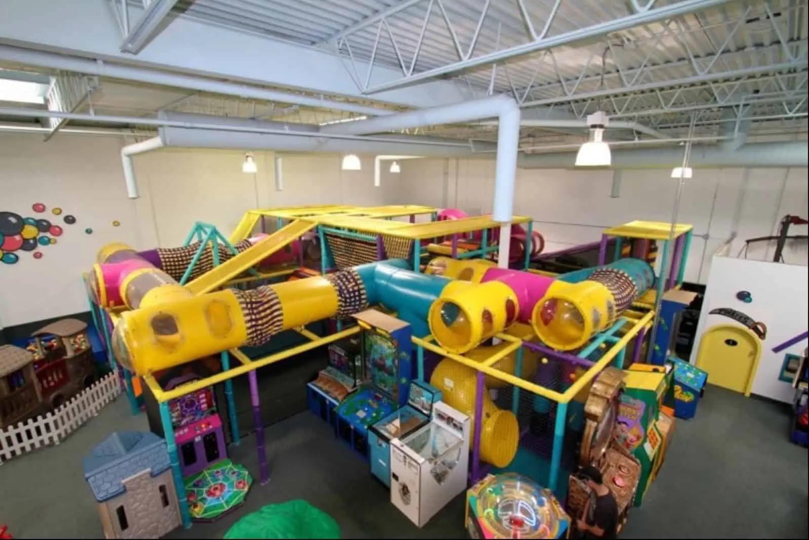 Colourful indoor play area with climbing structures and arcade games at Fun Factory in Saskatoon.