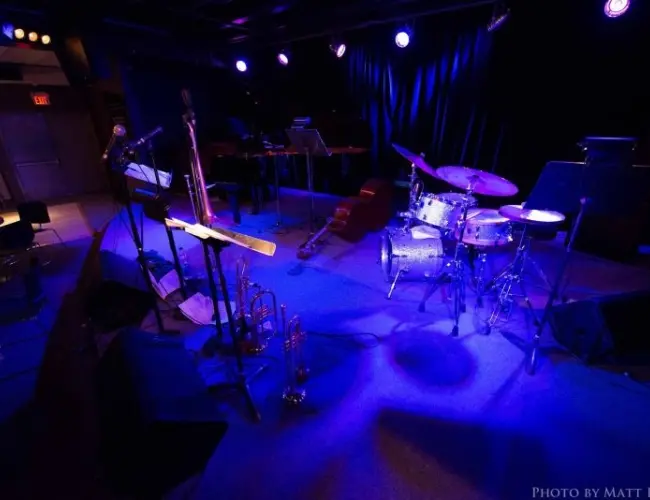 Intimate jazz venue The Bassment in Saskatoon with instruments set on stage.