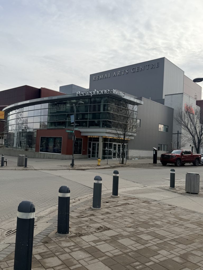 Exterior of Persephone Theatre at the Remai Arts Centre in downtown Saskatoon, featuring a modern glass-front entrance and curved façade