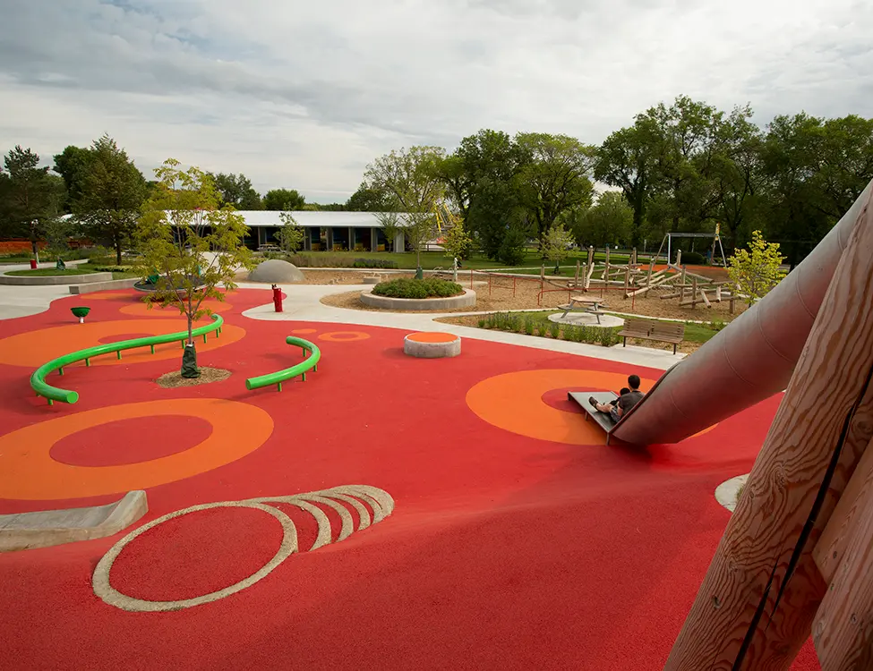 Accessible playground at Kinsmen Park featuring slides, climbing elements, and open play space.