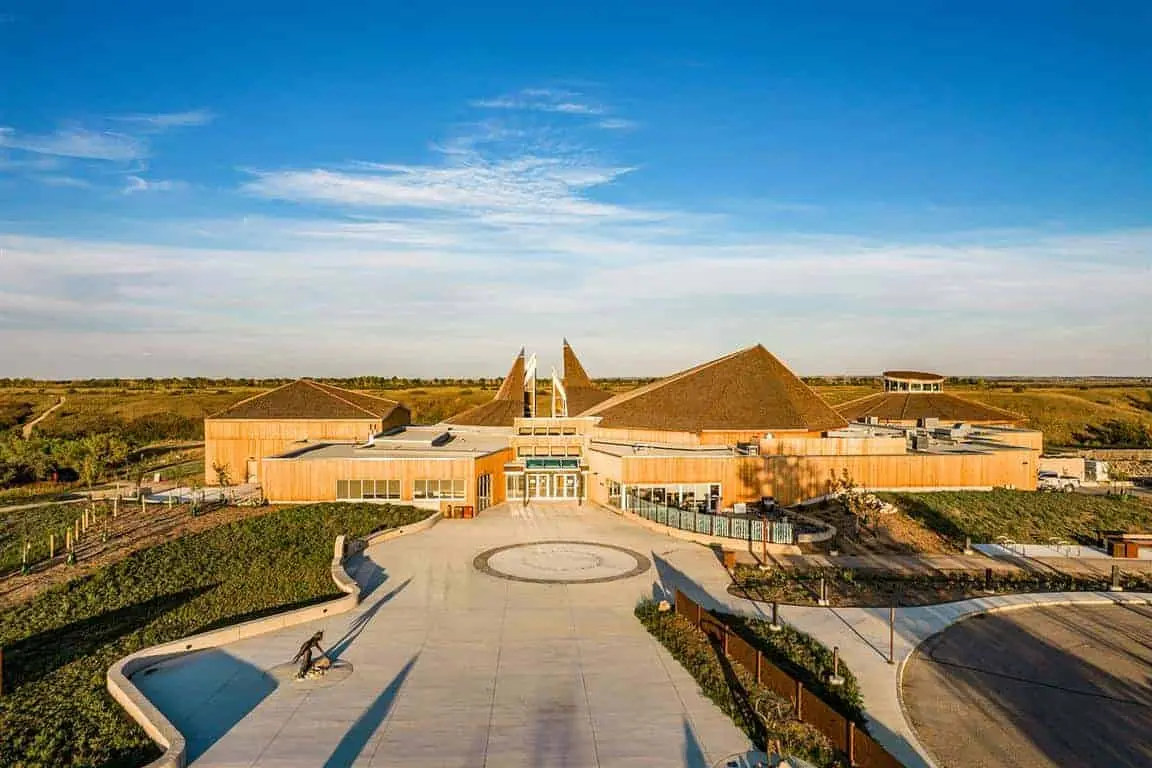 Wanuskewin Heritage Centre surrounded by prairie landscape under a wide Saskatchewan sky.