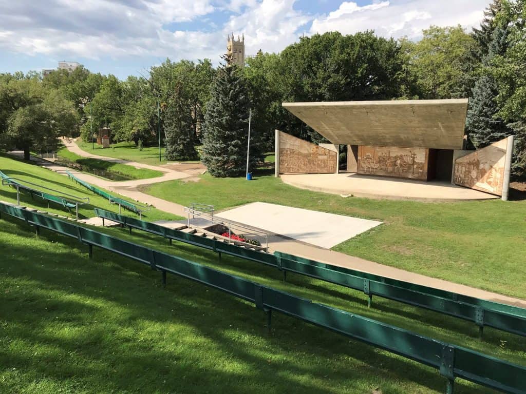 Moose Jaw on a Budget Amphitheatre at Moose Jaw's crescent park taken from across the river, showing green gas and benches for viewing
