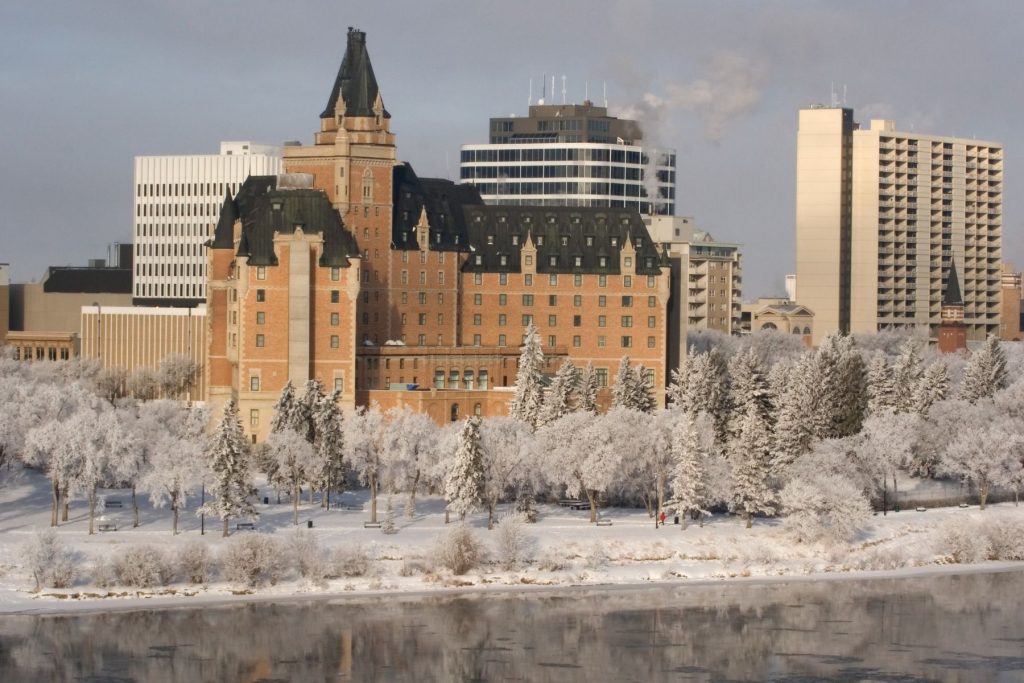 Where to Stay in Saskatoon View from across the river of the Delta Bessberough Hotel in winter.