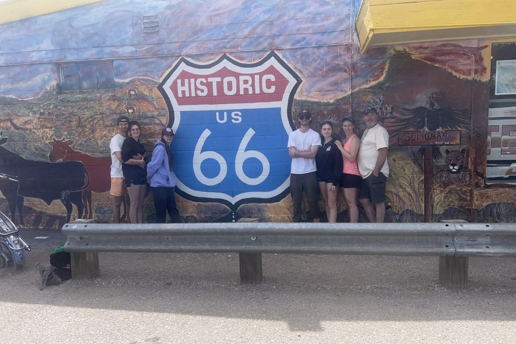 The family standing in front of a "Historic Route 66" mural in Seligman