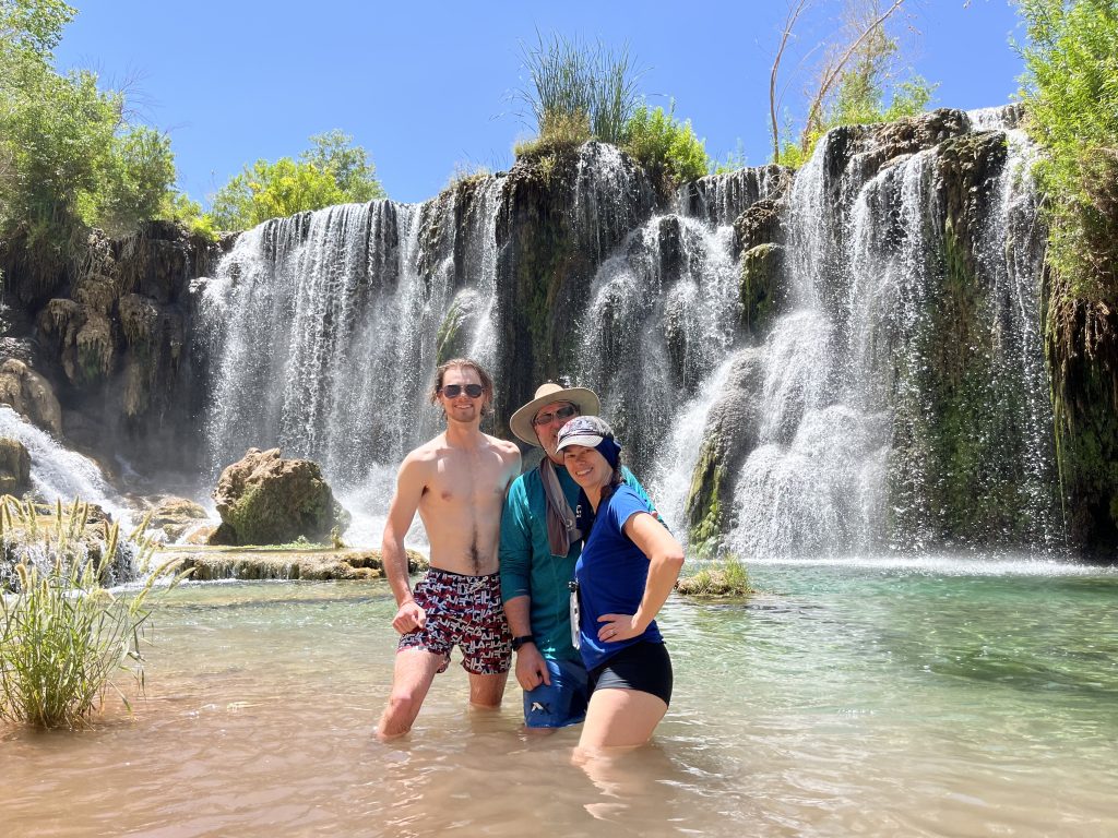 Joshua, Craig and Jen standing in the pool in front of Navajo Falls