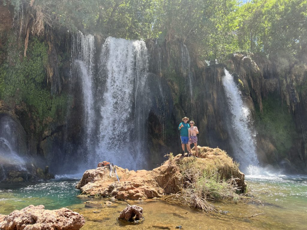 Joshua and Craig standing on boulders in front of Fifty Foot Falls