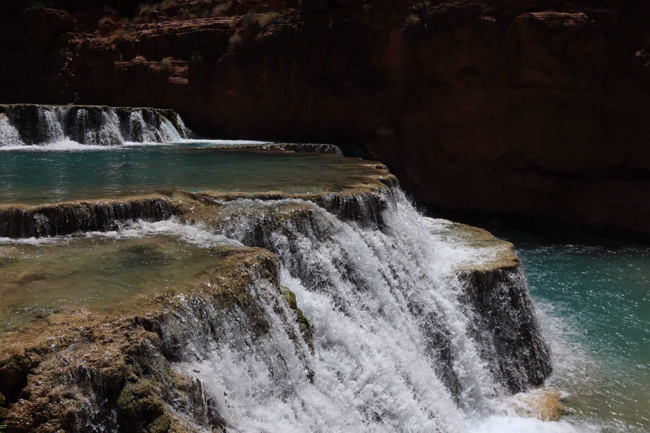 Tiered travertine waterfalls and turquoise pools at Beaver Falls in Havasupai.