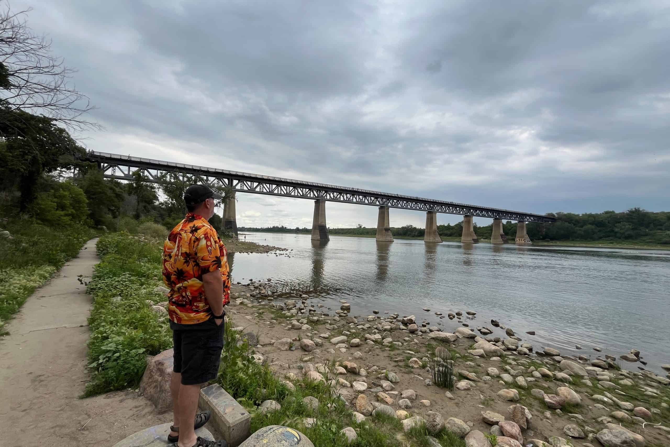 Historic CP Rail train bridge spanning the South Saskatchewan River in Saskatoon, viewed from the riverbank.