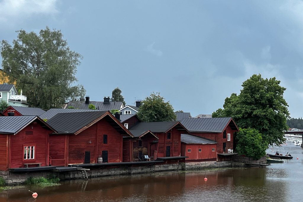 Line of red warehouses along the shore of the river in Old Porvoo