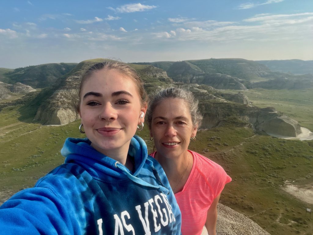 Big Muddy Badlands Saskatchewan Jen and Sarah standing on top of Casstle Butte with a view of the Big Muddy Badlands in Saskatchewan behind them