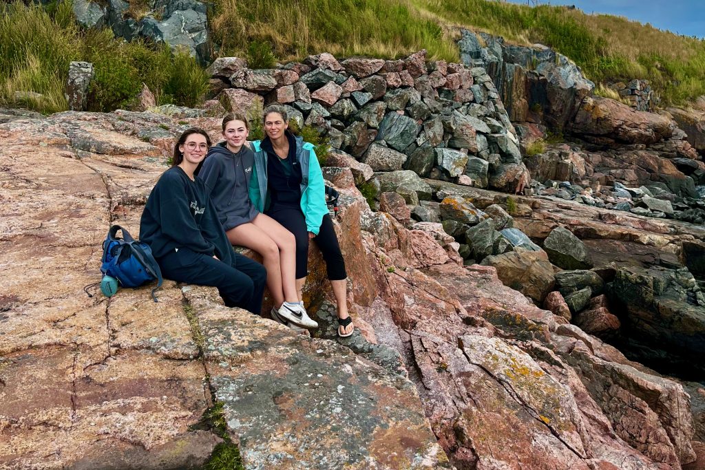 People sitting on the rocks beside the Baltic sea