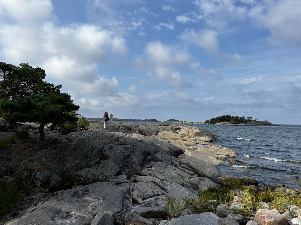Sarah walking along the rocks son the shoreline of the Baltic Sea