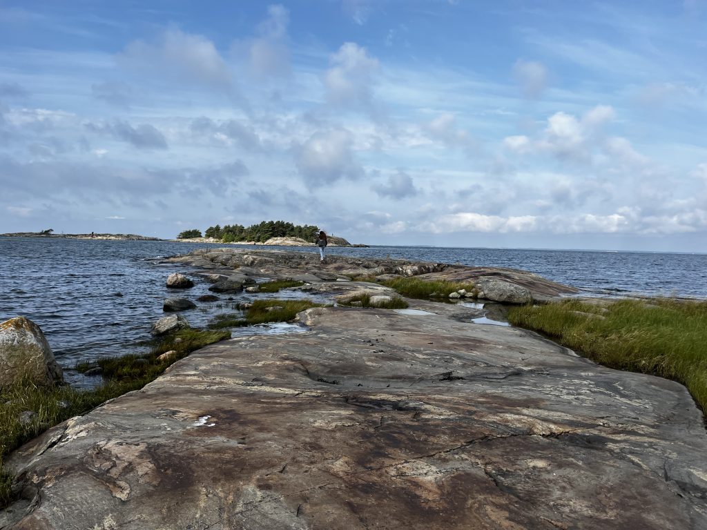 A peninsula of granite slabs in the middle of the Baltic Sea creating a dramatic coastline.
