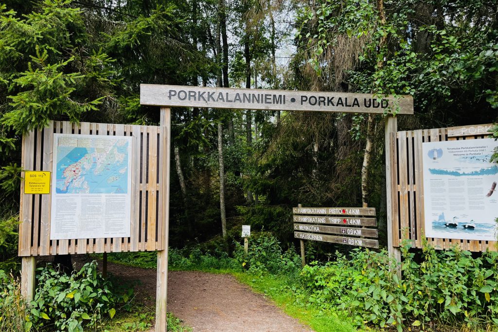 Signs and maps at the trailhead showing hikes and distances in the area.