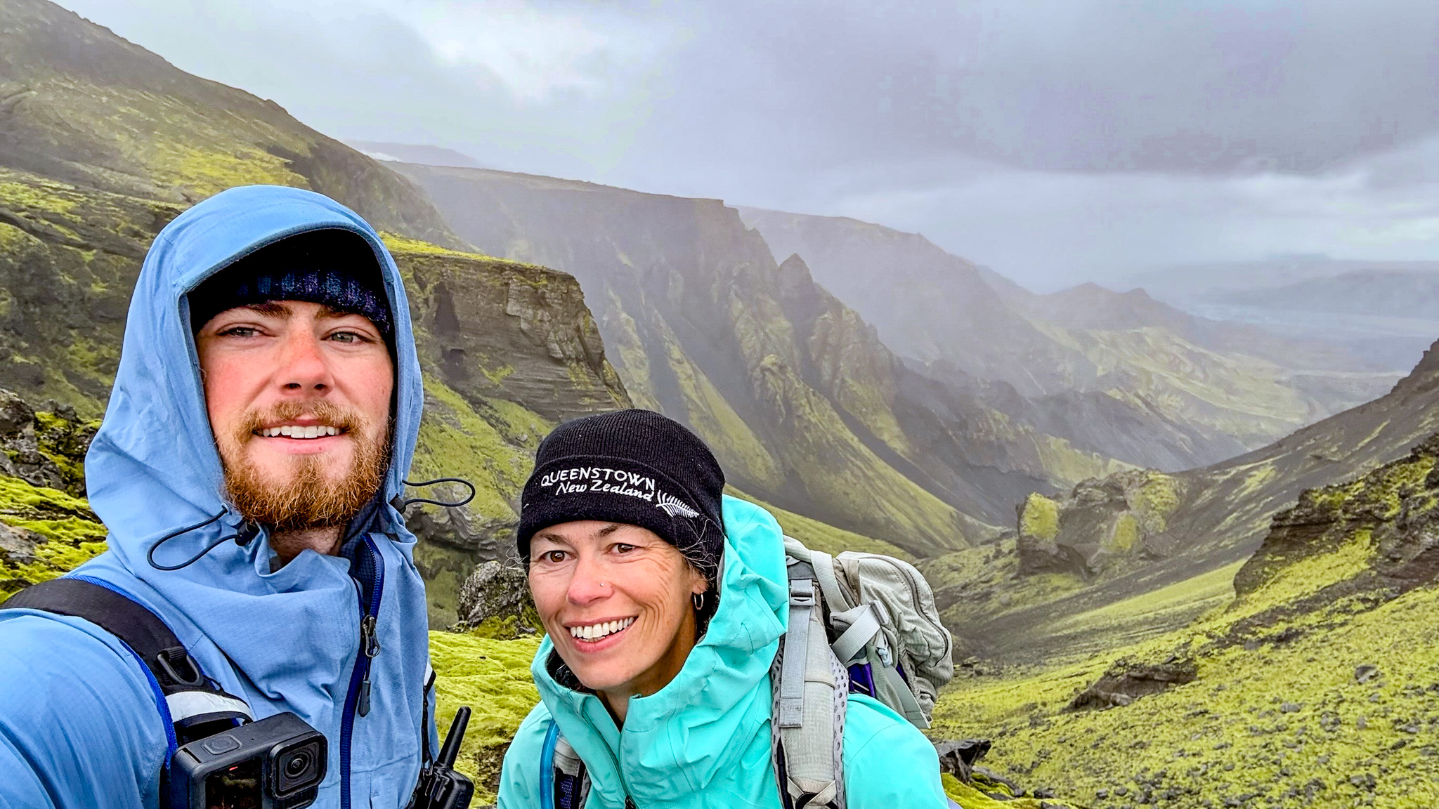 Laugavegur and Fimmvörðuháls combo Two hikers posing in front of a valley at the top of the first ascent on the Fimmvörðuháls