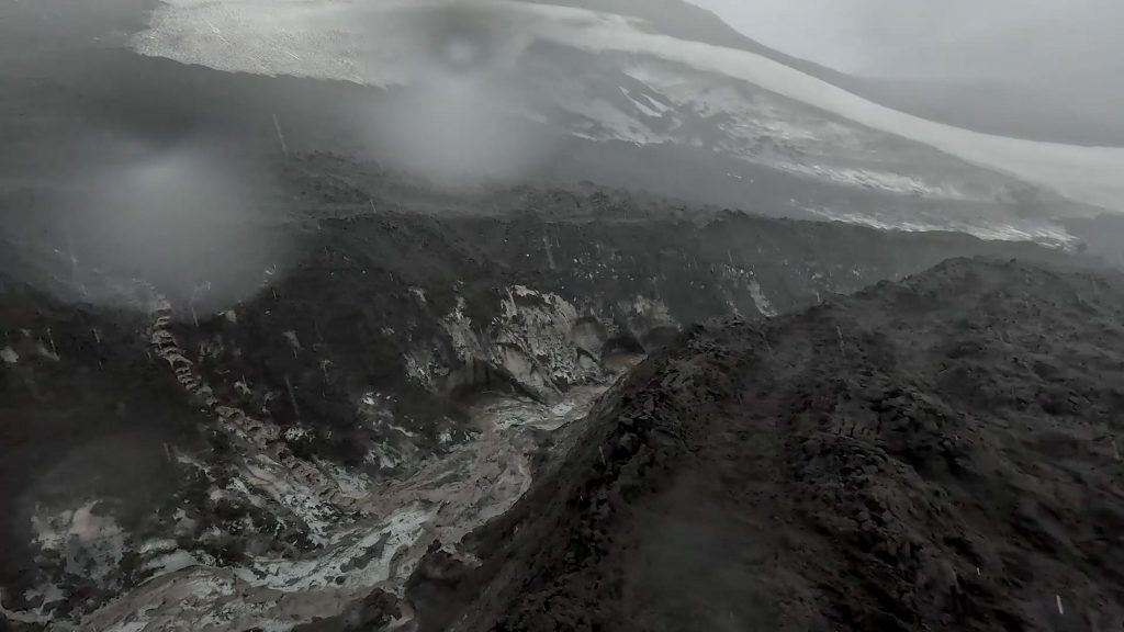 Laugavegur and Fimmvörðuháls combo The Skógá River carves through the black volcanic sand, ice and snow of the glacier of the Fimmvörðuháls Trail before the Baldvinsskáli hut