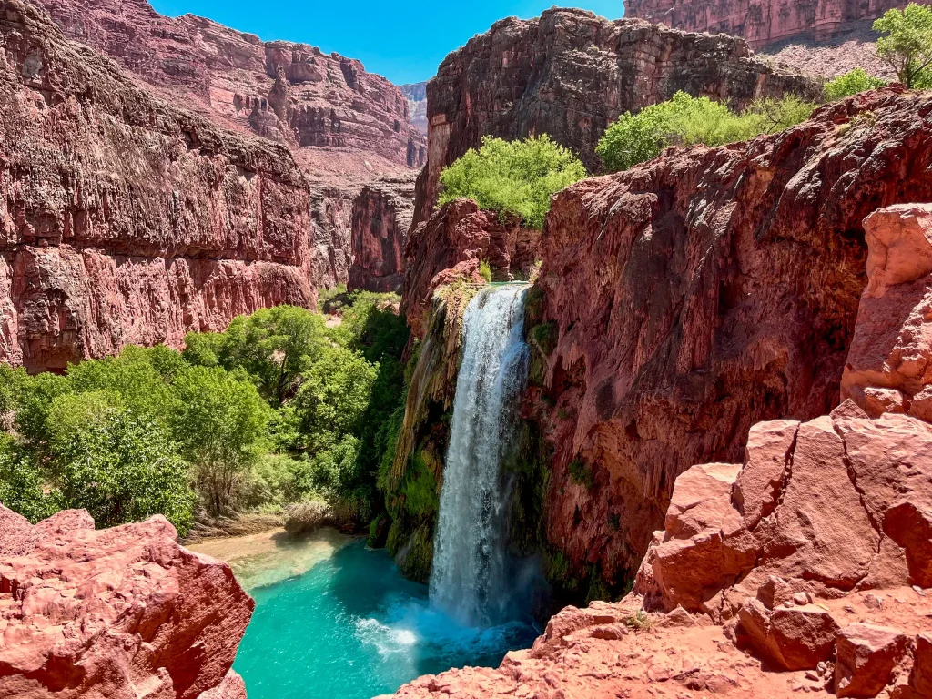 Plunging Havasu Falls surrounded by red rock cnayon walls