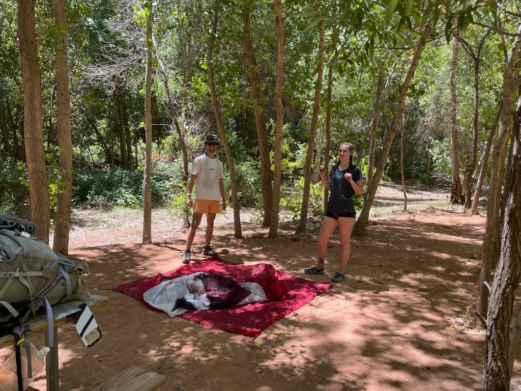 Two hikers getting ready to set up their tent in the Havasupai campground.