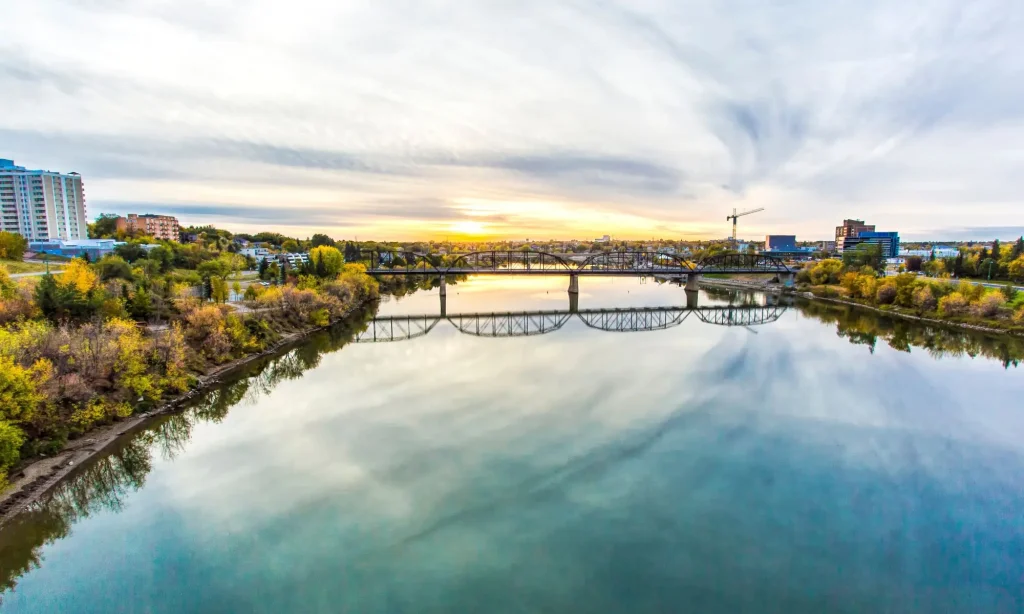 Saskatoon skyline and bridges over the South Saskatchewan River at sunset
