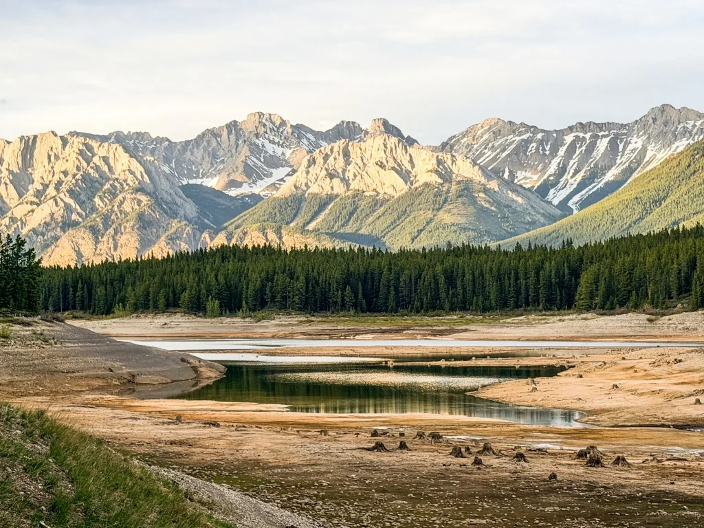 Rocky shoreline and low water levels at Lower Kananaskis Lake near Interlakes Campground